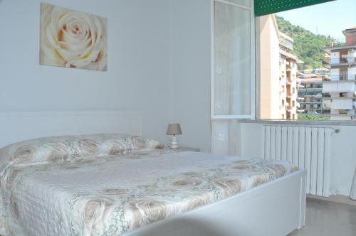 a white bed in a room with a window at Aldebaran B&B in Cava deʼ Tirreni