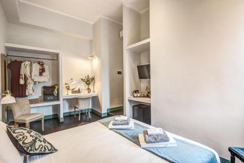 a bedroom with a bed and a dressing room at Tree Charme in Rome