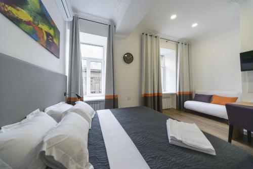 a bedroom with a large bed with white pillows at Partner Guest House Khreschatyk in Kyiv