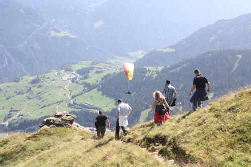 a group of people standing on a hill with a kite at Bella Vista Apart in Fiss