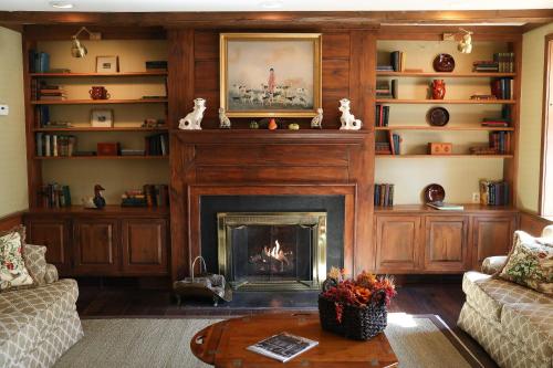 a living room with a fireplace and a couch at Golden Plough Inn in New Hope