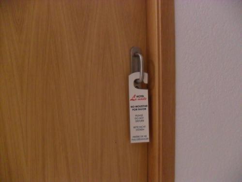 a door with a sign attached to it at Hotel Lo Monte in Pilar de la Horadada