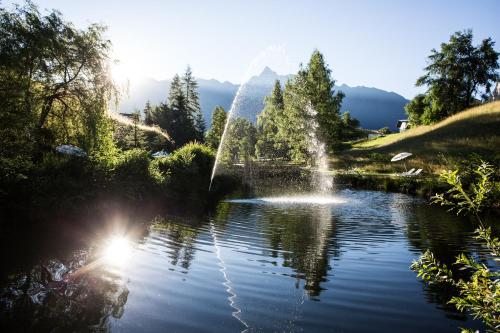 a fountain in the middle of a pond at Ferienwohnungen Ötztal in Sautens