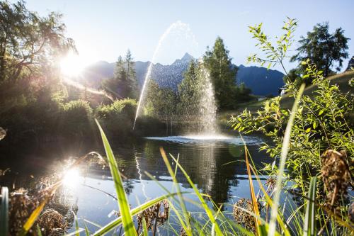 a fountain in the middle of a body of water at Ferienwohnungen Ötztal in Sautens
