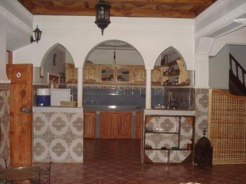 a large kitchen with arches and a counter top at Gîte Imarin in Agouti