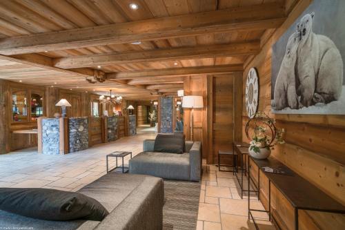 a living room with a couch and a chair at Les Chalets Du Gypse in Saint-Martin-de-Belleville