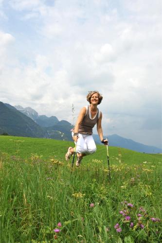a woman is running through a field of grass at Petra Maria Sölle - Ferienhaus sehr privat in Presseggersee