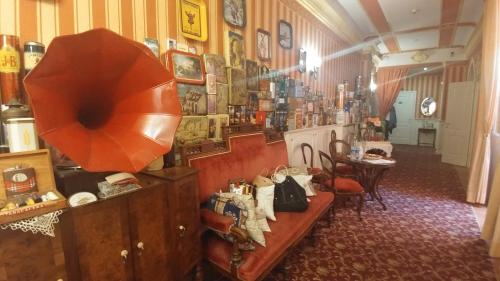 a room with a couch and a table in a store at Il Canale Hotel in Bologna