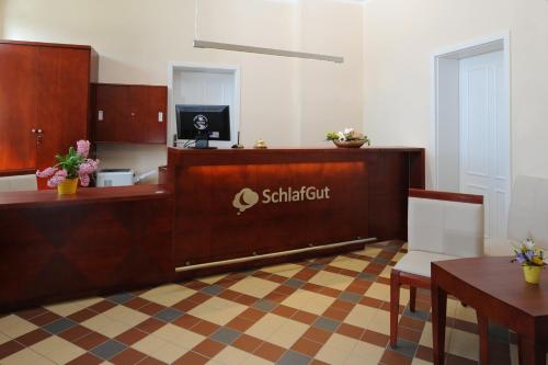 a waiting room with a reception desk in at SchlafGut AppartementHotel in Leipzig