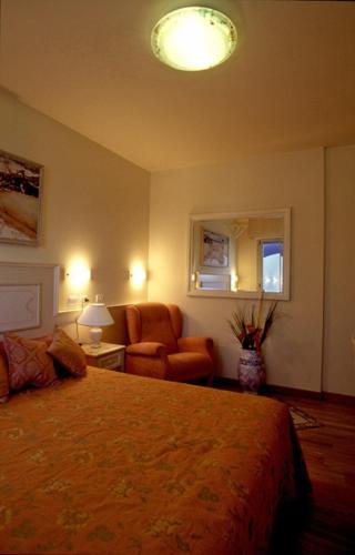 a bedroom with a bed and a couch and a chair at Residence Darsena in Cattolica