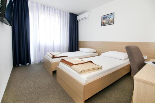 a hotel room with a bed and a desk at Hotel Zagreb in Split