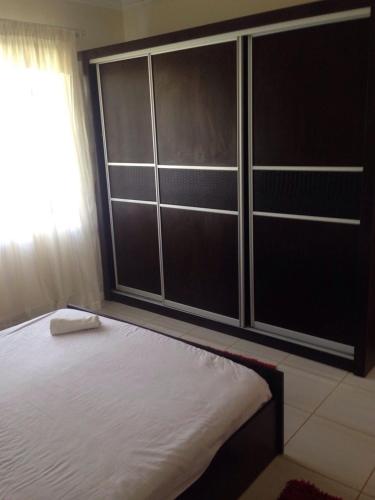 a bedroom with a bed with a large closet at Delta Sharm Apartment in Sharm El Sheikh