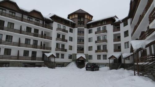 a large building with snow in front of it at Crystalville in Bakuriani