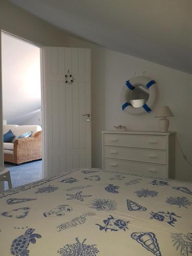 une chambre avec un lit et une commode dans l'établissement Mansarda Camelie via dei Normanni, 45, à Campofelice di Roccella