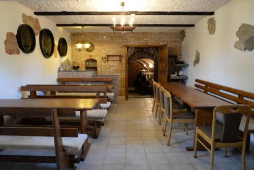 a dining room with wooden tables and chairs at Ubytování u rybníka Bořetice in Bořetice