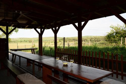 a wooden table on a porch with a view of a field at Ubytování u rybníka Bořetice in Bořetice