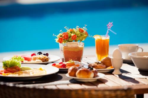 a table topped with plates of food and drinks at Ibis Jerez De La Frontera Cadiz in Jerez de la Frontera