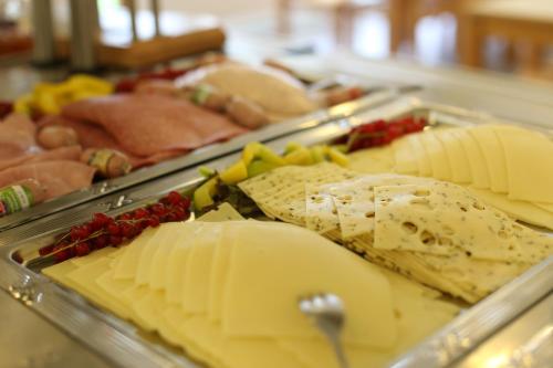 a tray of cheese and other foods on a buffet at Jugendherberge Heide in Heide