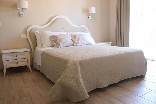 a bedroom with a large bed with a white bedspread at Le camere di Villa Incanto in Colonnella