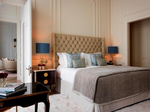 a bedroom with a large bed and a table at The Kensington Hotel in London