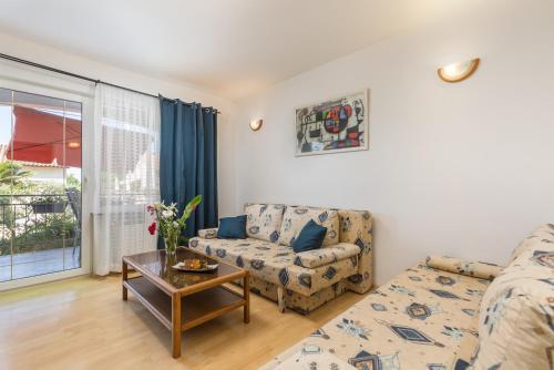 a living room with a couch and a table at Villa Tina Porec in Poreč