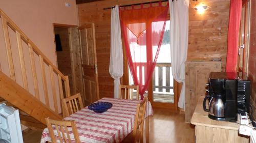 a dining room with a table and a window at LA GRANGE DE HAUTE-JOUX in Les Fourgs
