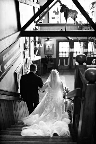 a bride and groom walking down the stairs at Golden Plough Inn in New Hope