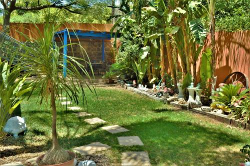 a garden with a palm tree in the grass at Ayelet Ahavim in Livnim