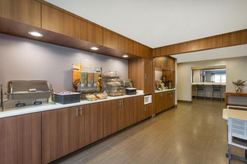 a large room with wooden cabinets and a food counter at Microtel Inn & Suites by Wyndham in Sandston