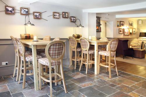 a dining room with a table and chairs at Flower Pot Hotel in Sunbury