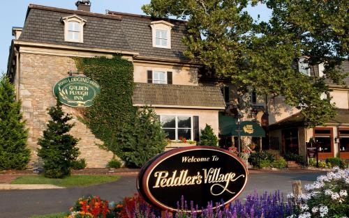 a sign in front of a building with a house at Golden Plough Inn in New Hope