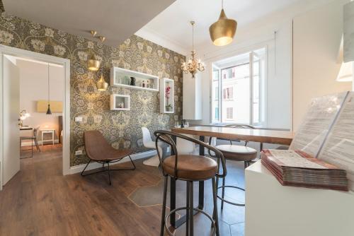 a living room with a bar and chairs and a table at Guest Roma House in Rome