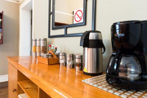 a coffee maker sitting on top of a wooden counter at NANNA ROUS' TOWN HOUSE in Colesberg