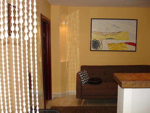 a living room with a couch and a window at Apartament Central in Piatra Neamţ