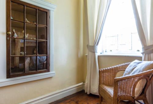 a room with a window and a chair next to a chair at NANNA ROUS' TOWN HOUSE in Colesberg