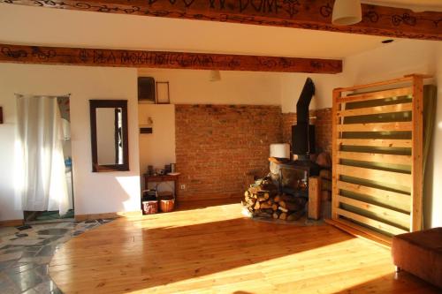 a living room with a wood stove in a room at Chata nad Wisłą u Macieja in Dobrzyków