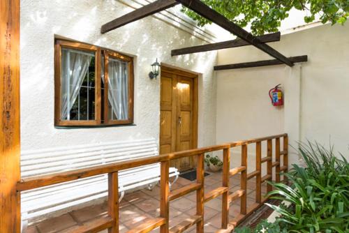a front porch of a house with a wooden door at NANNA ROUS' TOWN HOUSE in Colesberg