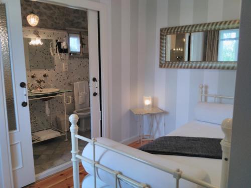 a small bedroom with a bed and a bathroom at Casona Camino de Hoz in Anero
