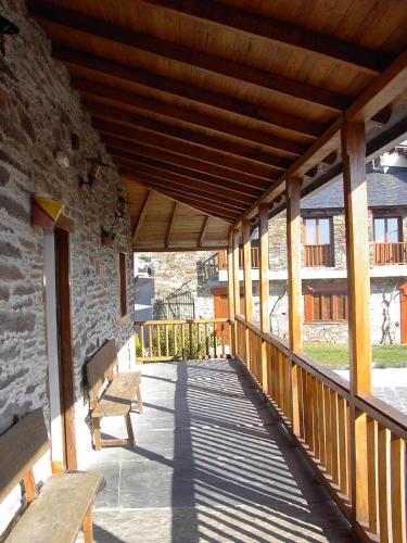 a wooden porch with benches on a building at A Salanova in Salcedo