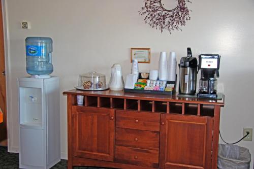 a wooden dresser with a blender on top of it at Potsdam Inn in Potsdam