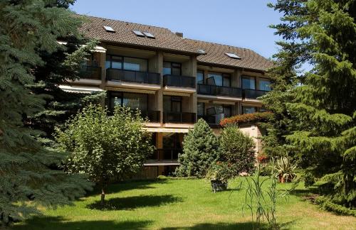 an exterior view of a building with trees at Hotel Sonnenhügel in Bad Bevensen