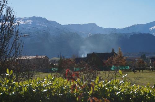 a field with houses and mountains in the background at Haven Suite Luxury 5 Star in Queenstown