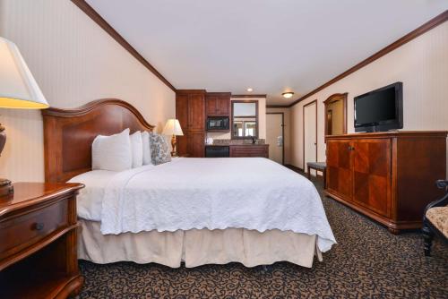 a hotel room with a bed and a flat screen tv at Best Western Edgewater Resort in Sandpoint