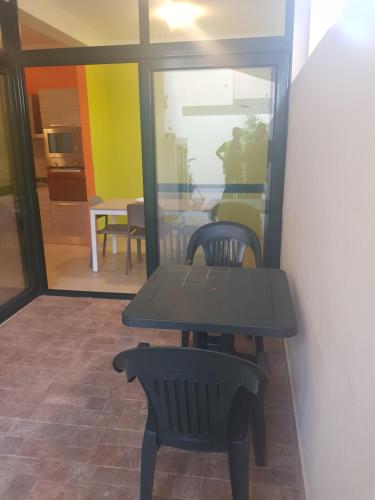 a table and two chairs in a room at Surf House Cabo Verde in Santa Maria