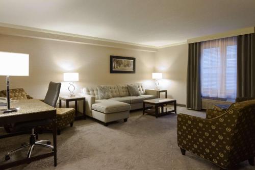 a living room filled with furniture and a tv at Best Western PLUS The Arden Park Hotel in Stratford