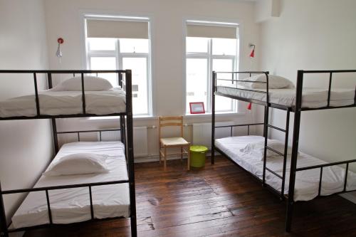 a room with three bunk beds in it at Akureyri Backpackers in Akureyri