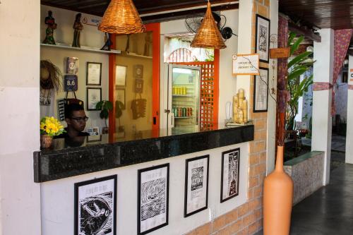 a restaurant with pictures on the wall at Vila Aju - Pousada Temática in Aracaju