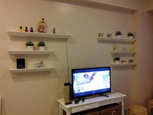a tv sitting on a table in a room at Palm Tree Condos across NAIA3 by Beth in Manila