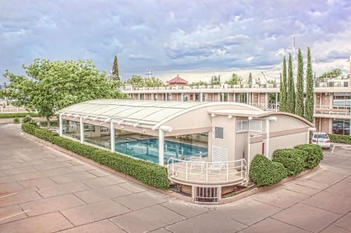 a building with a pool in front of a building at HM Mirador in Chihuahua