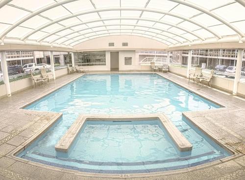 a large swimming pool with a glass ceiling at HM Mirador in Chihuahua